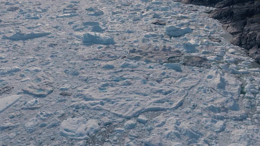 Sunlight shines on snow and ice melting in the arctic