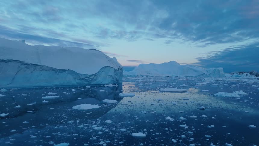 Several icebergs sit in the middle of the water
