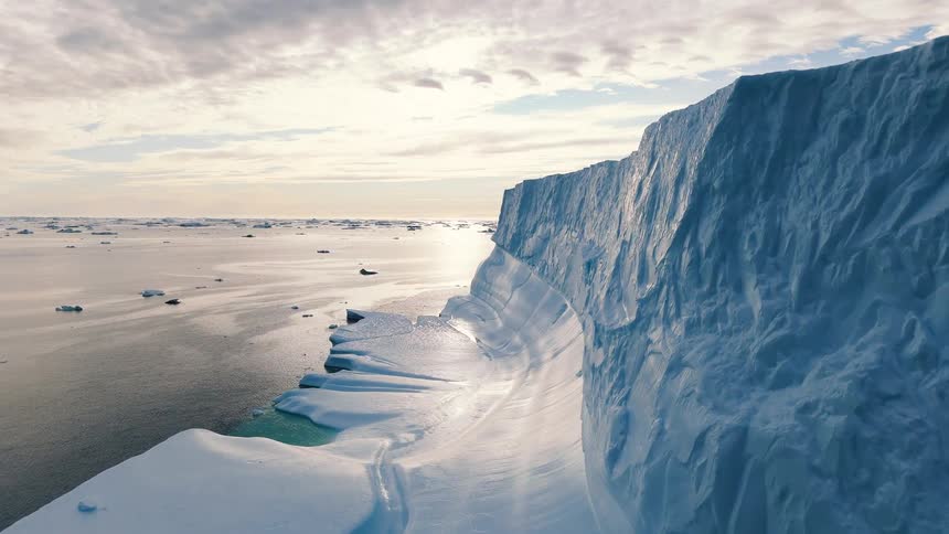 Melting iceberg and ice floating on the arctic water as ships sail