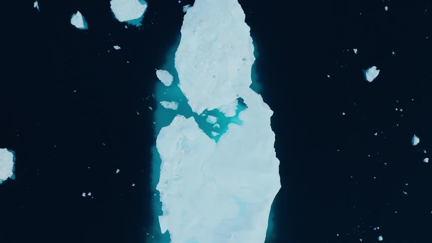 Birds eye view of large iceberg in the arctic ocean at night