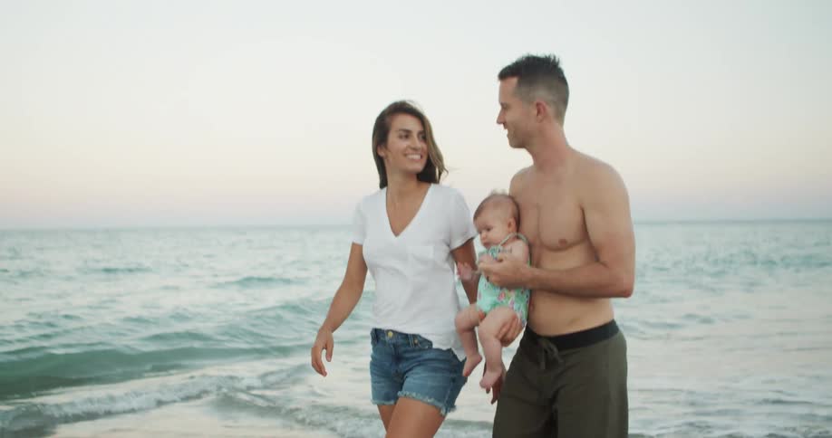 The family are walking on the beach together