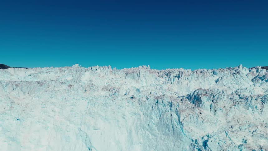 Pieces of broken and melting ice floating along the arctic coast