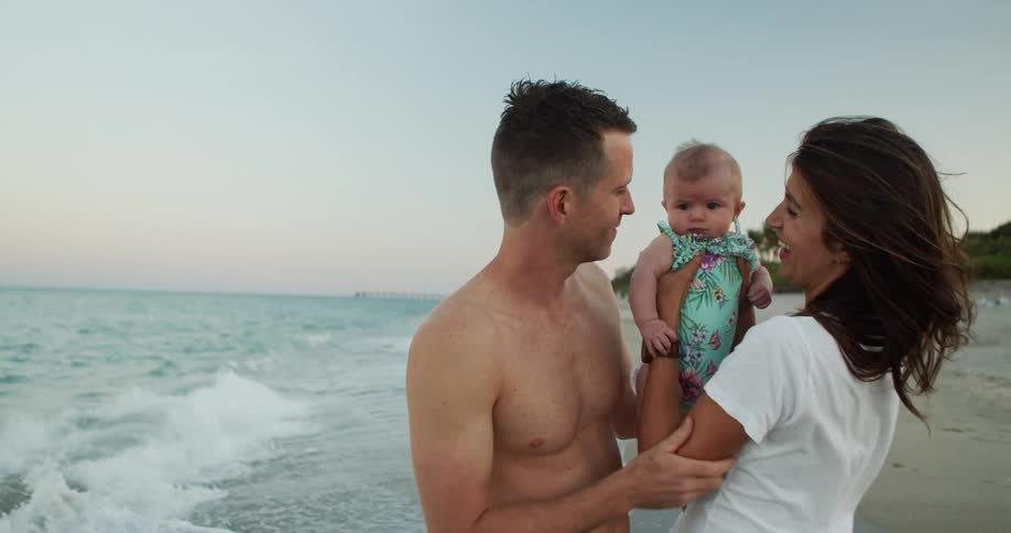 Family enjoying quality time on the beach at dusk