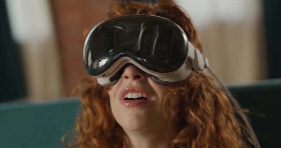The woman is having fun looking around using a vr headset