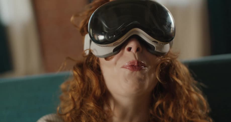 Teenage girl wearing a virtual reality headsetsmiles and looks around
