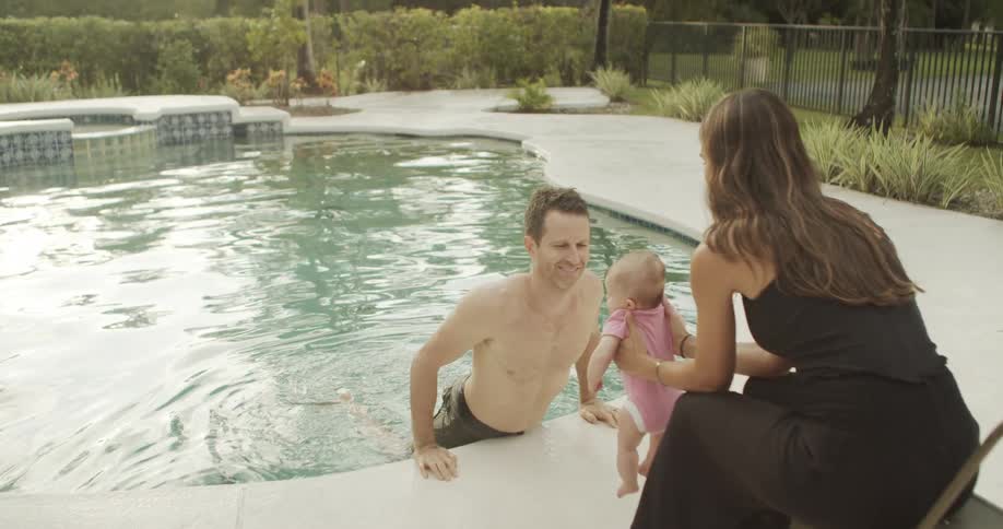 A family enjoys vacation time together by the pool at a resort