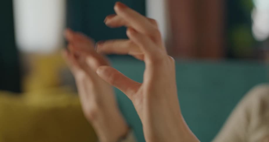 The woman stretches and pinches her fingers