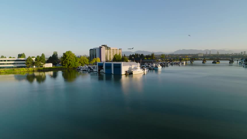 City skyline with a marina and boats at dusk