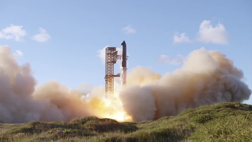 A rocket lifts off from a coastal launch pad with flames and smoke