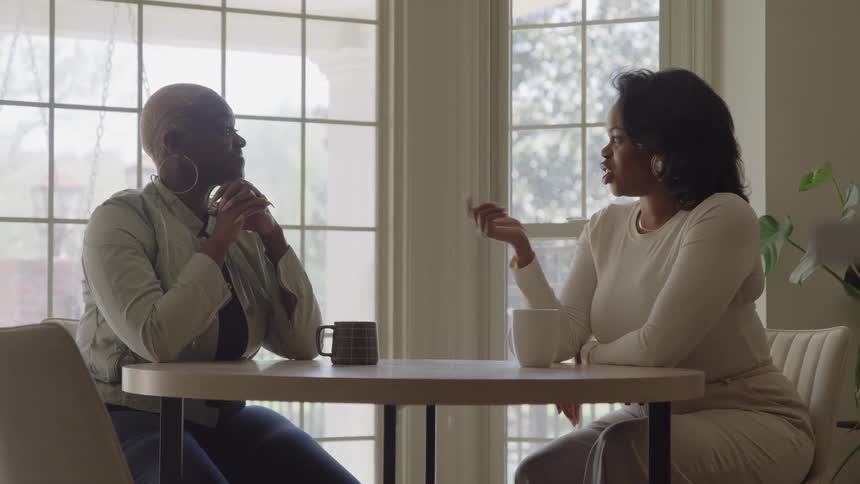 Two women talk and have coffee