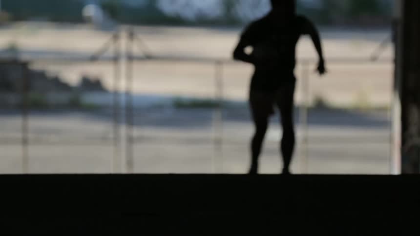 Person runs with a ball in their hands