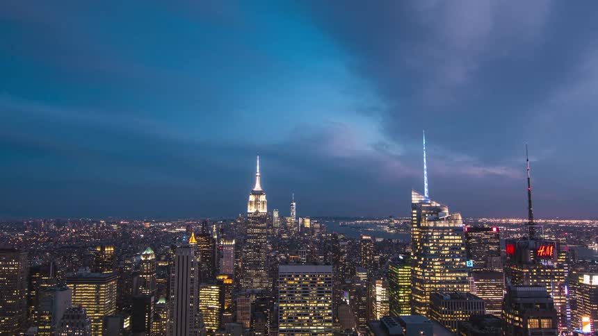 All the buildings in the city light up as the sun sets