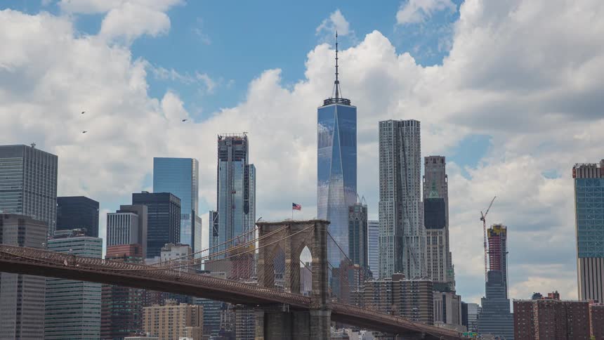 Tall modern buildings and skyscrapers on the city skyline as clouds move overhead