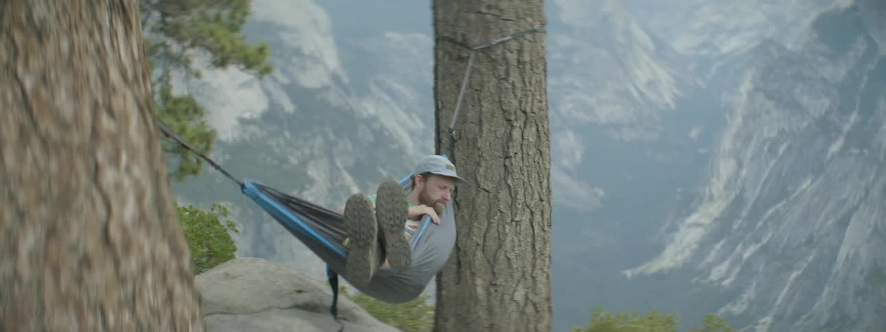 Man laying in hammock in mountain wilderness