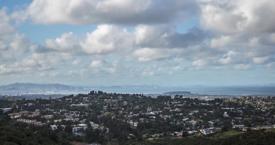 An aerial view of a city filled with residential buildings at midday