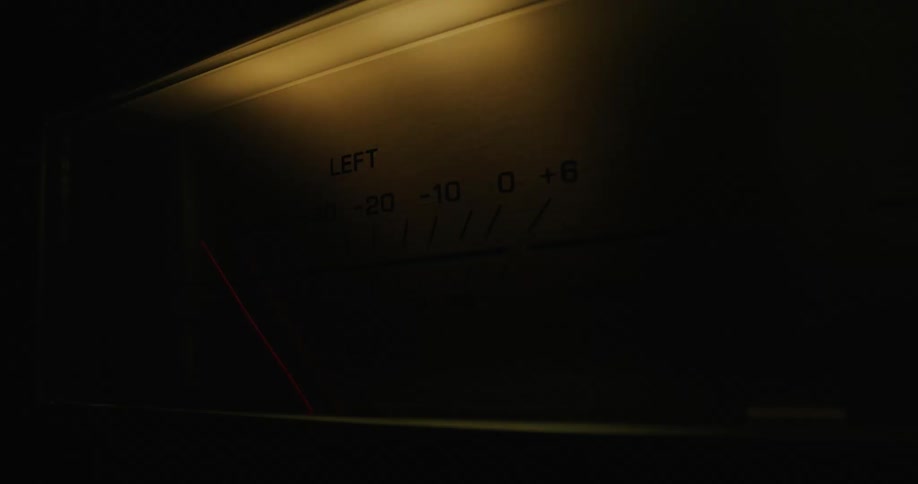 The needle of an analogue volume unit meter bounces back and forth