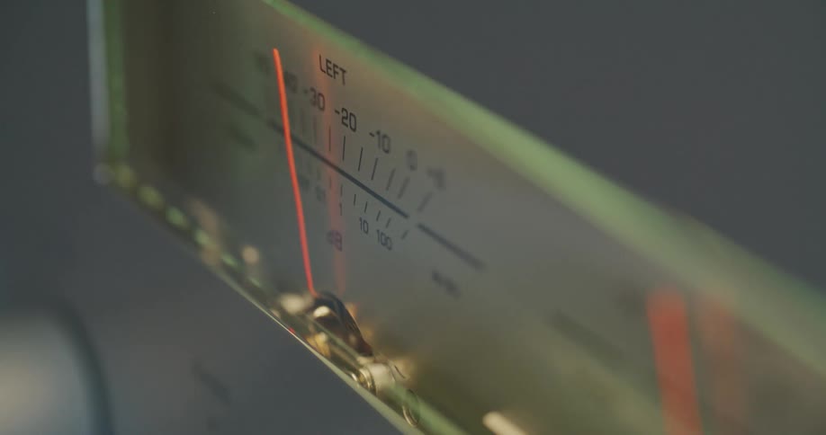 Needles jitter on the left and right sound decibel meters on a piece of audio equipment
