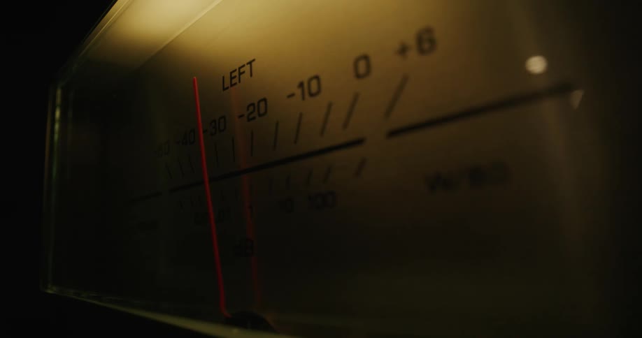 Needle moves across the surface of an analog sound decibel meter