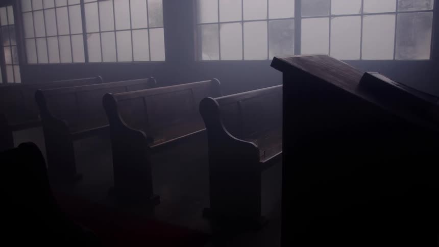Dust floats in the sunlight streaming into an empty church