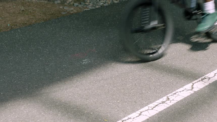 A person rides their bike down a street