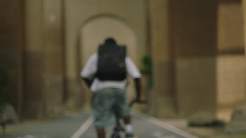 The man rides his bike on the bike trail