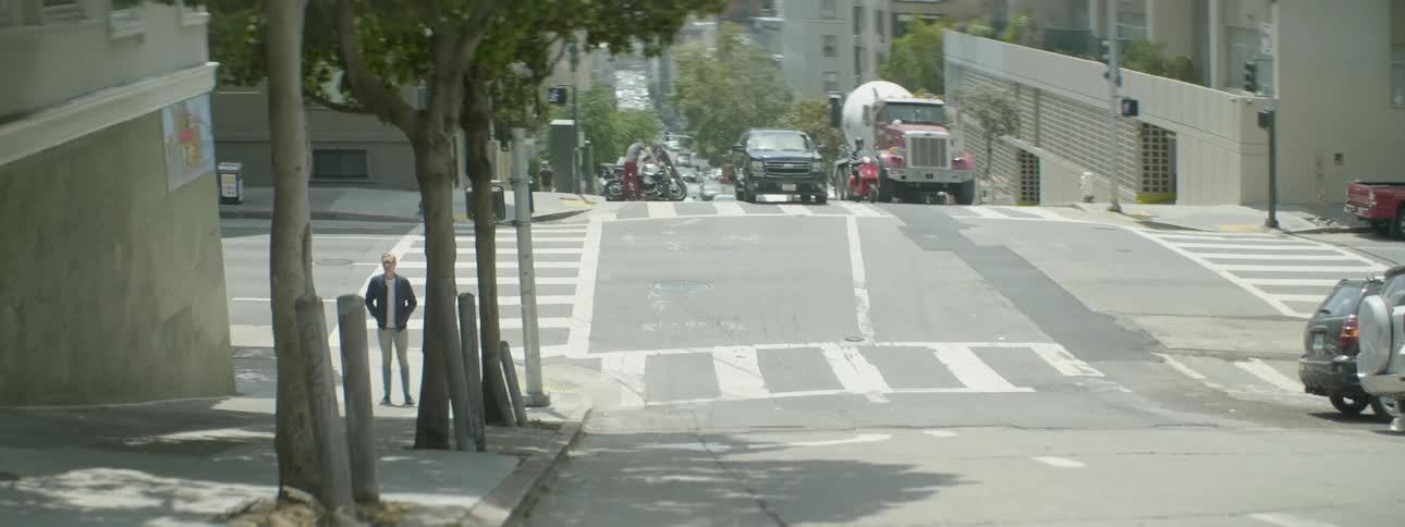 A man is standing on the street corner ahead