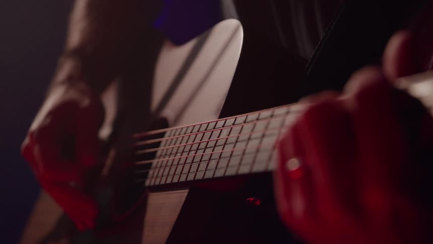 Musician playing an acoustic guitar
