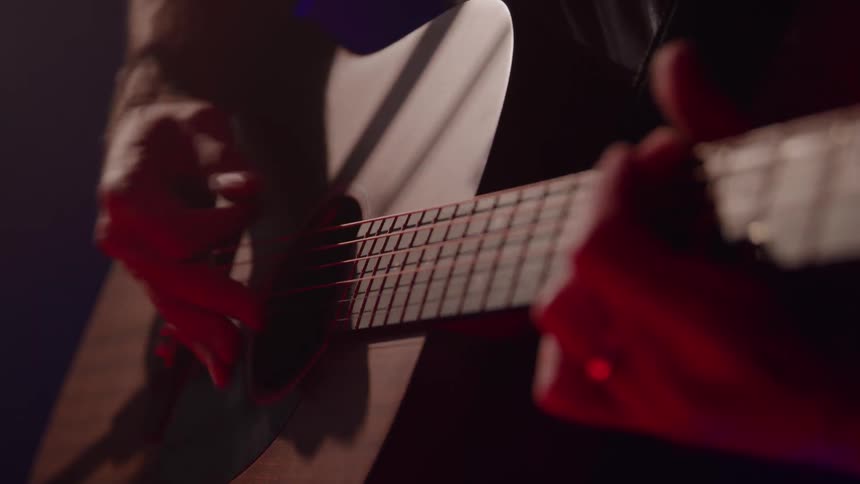 Musician plays an acoustic guitar