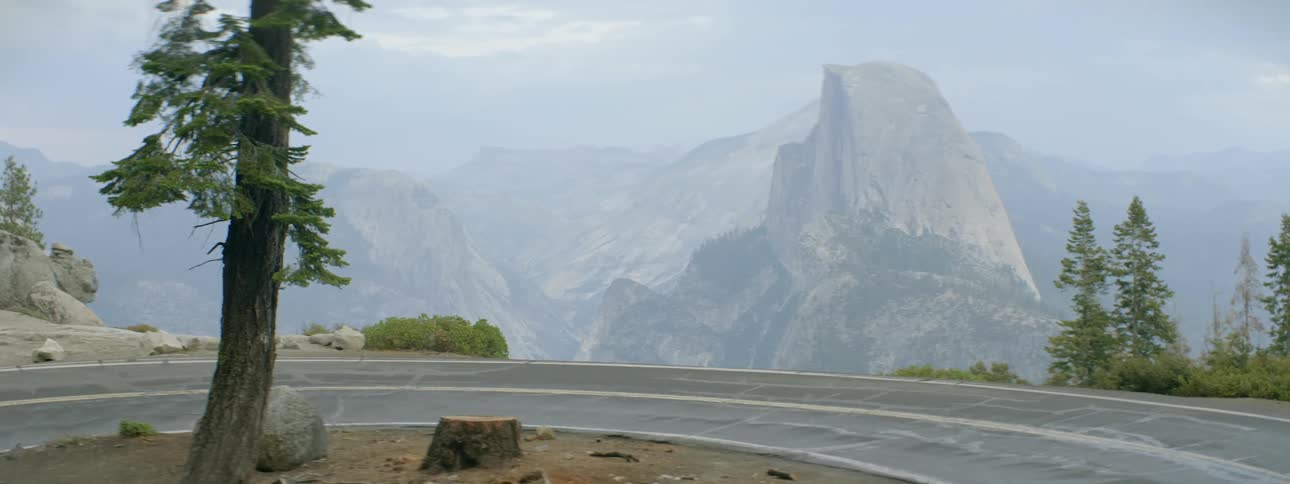 A truck turns around on a road on a cliff