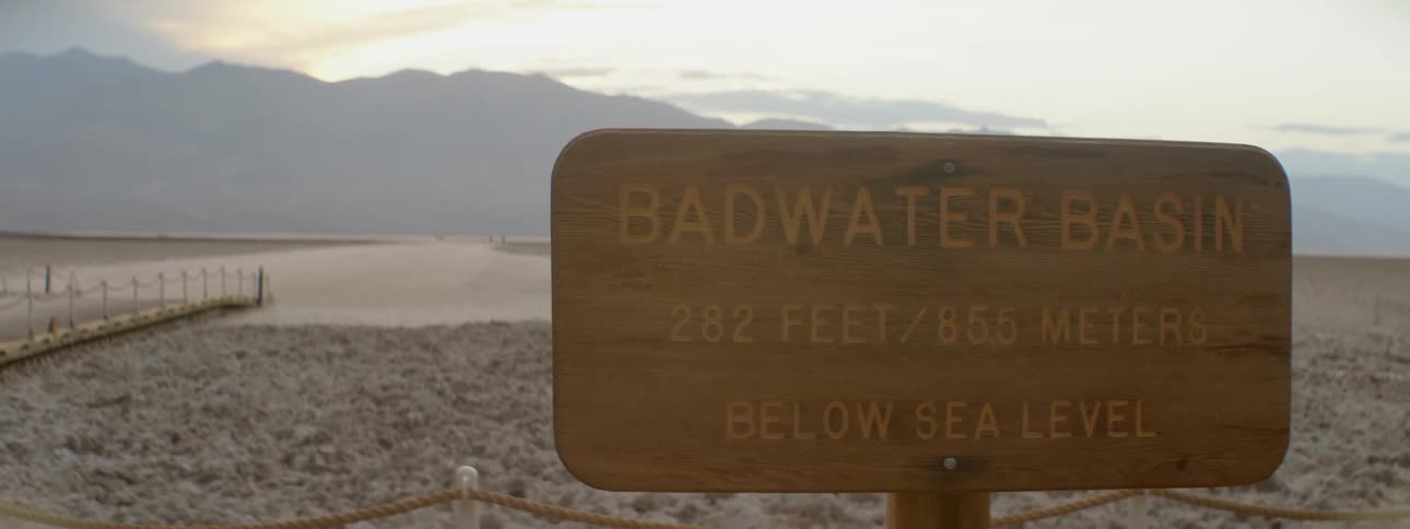 Sign in front of a rocky beach