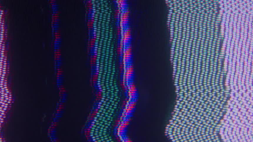 Closeup patterns of red green and blue screen pixels warp and shift creating a mesmerizing wall of digital static and visual noise