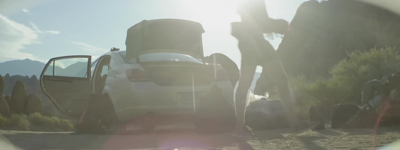 People walk past a car parked