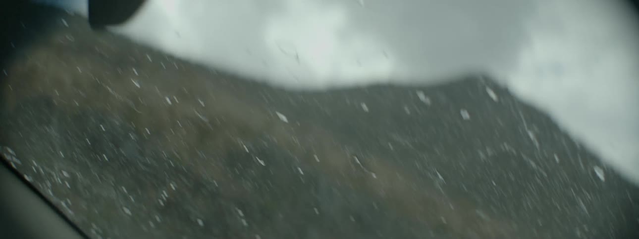Windshield wipers wiping raindrops from vehicle windshield