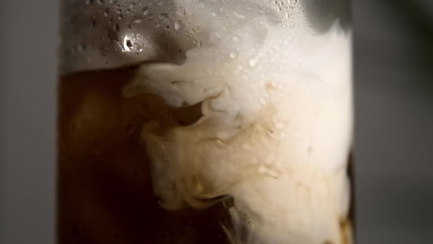 Cream is poured into the drink