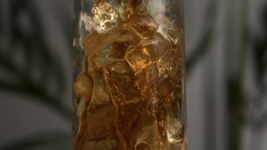 Beverage flows into an ice filled glass