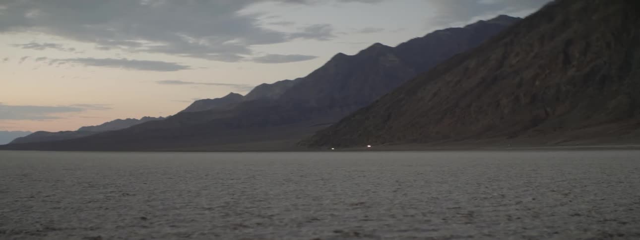 Mountains stand in the distance at sunset