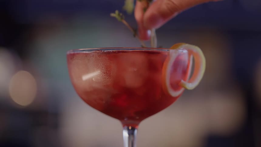 A person is using a stem to stir a beverage