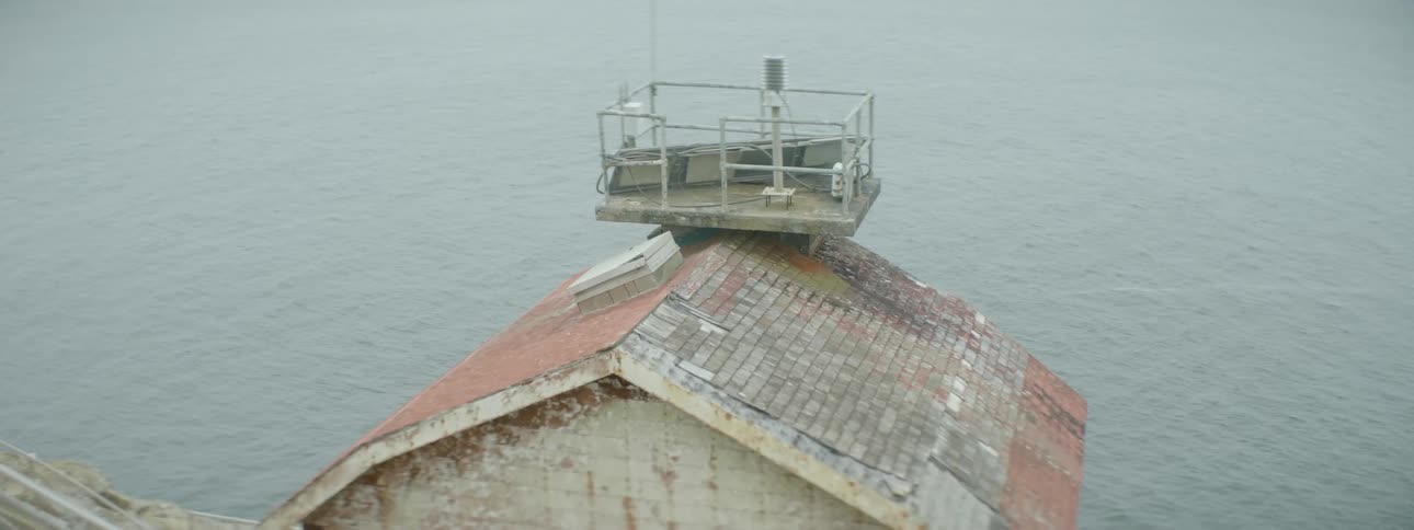 An old building sits next to a body of water