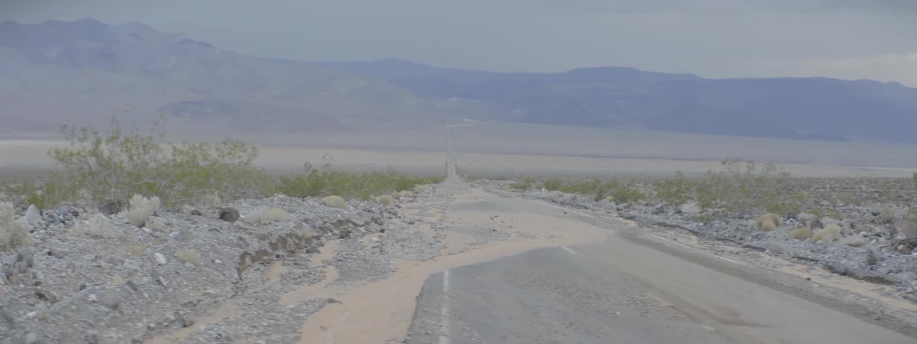 A road is covered with puddles and mud