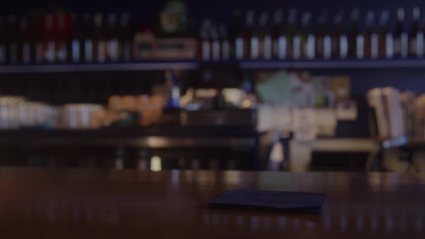 A person picks up a glass