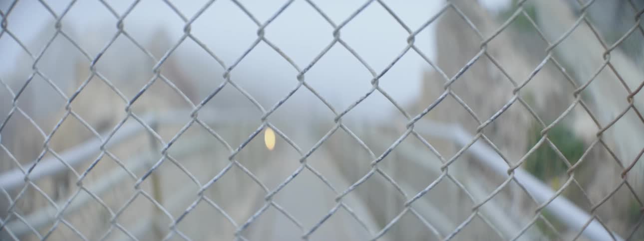 A chain link fence over a street