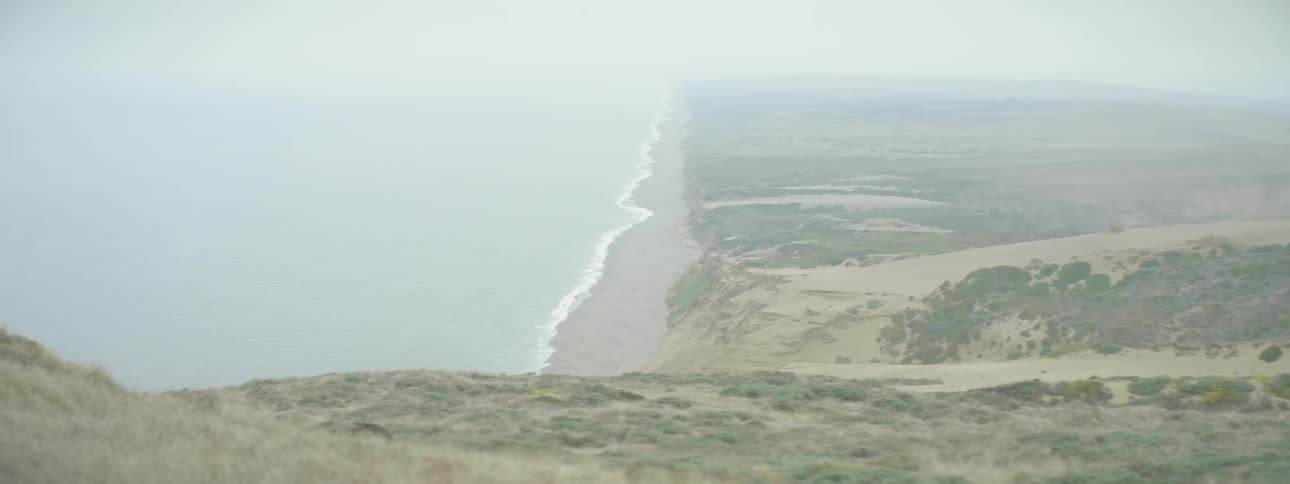 The ocean and sandy beach are shown in the distance