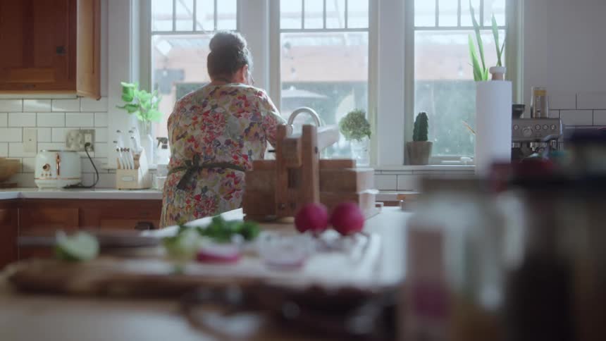 Woman works in her sunny kitchen