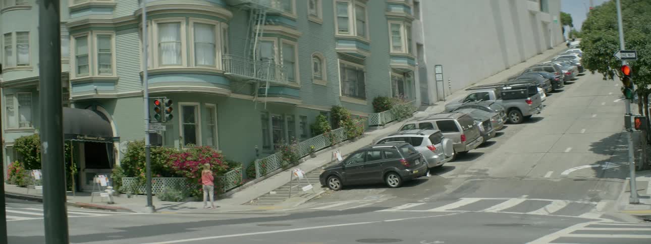 Cars are parked along a city street
