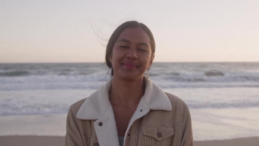 A woman smiles at the camera
