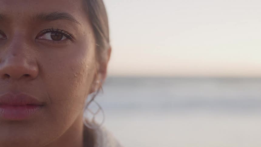 The woman blinks her eyes outside