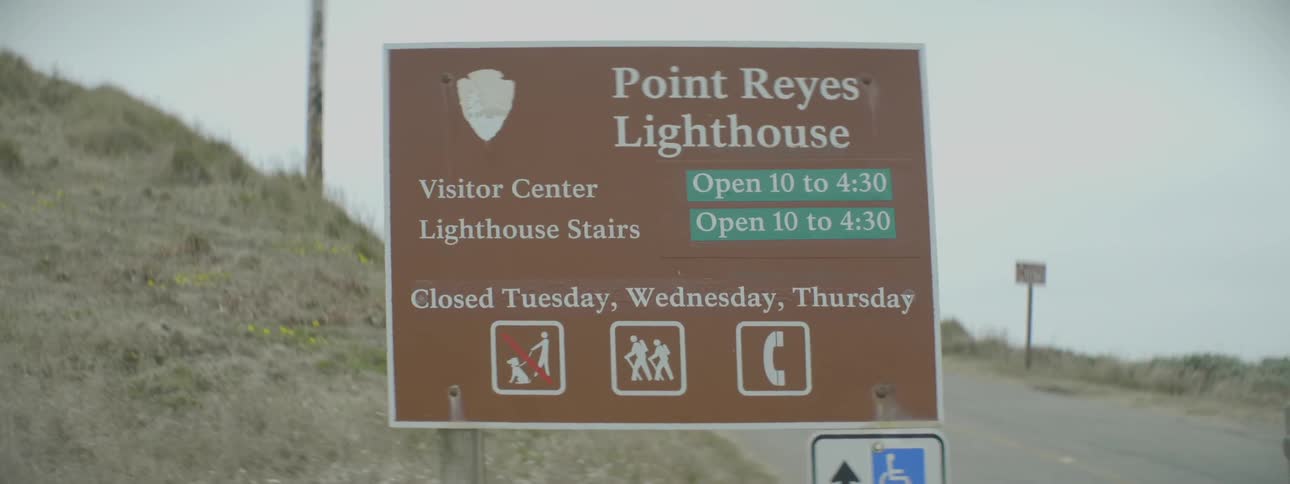 A sign is shown next to a road