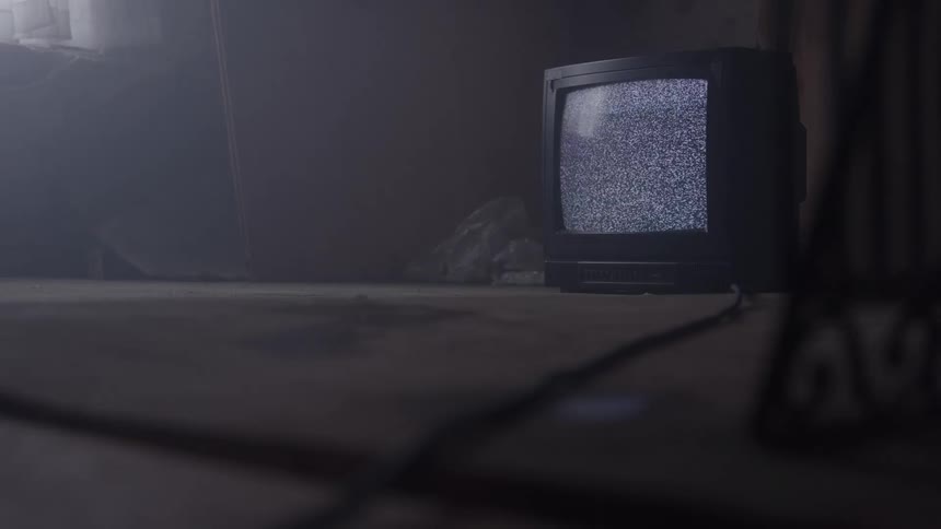 The television on the floor is full of static