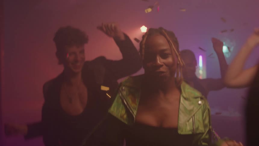 Young people dancing on disco music in a club