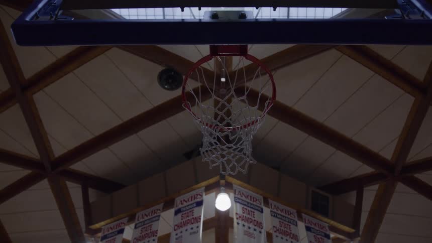 The inside of a gym with a basketball hoop
